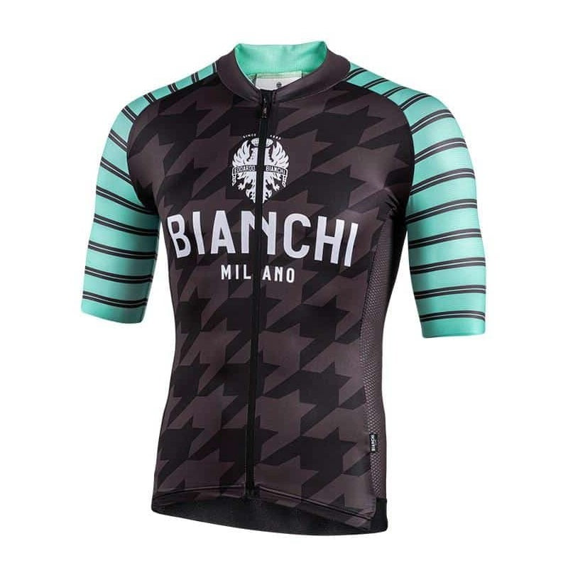A cycling jersey with short sleeves, featuring a geometric pattern with black, gray, and green colors. The jersey has 'BIANCHI MILANO' branding on the chest.