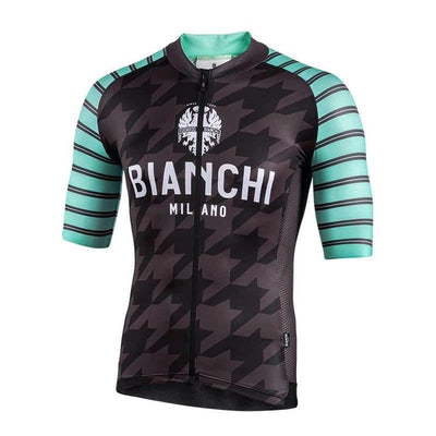 A cycling jersey with short sleeves, featuring a geometric pattern with black, gray, and green colors. The jersey has 'BIANCHI MILANO' branding on the chest.
